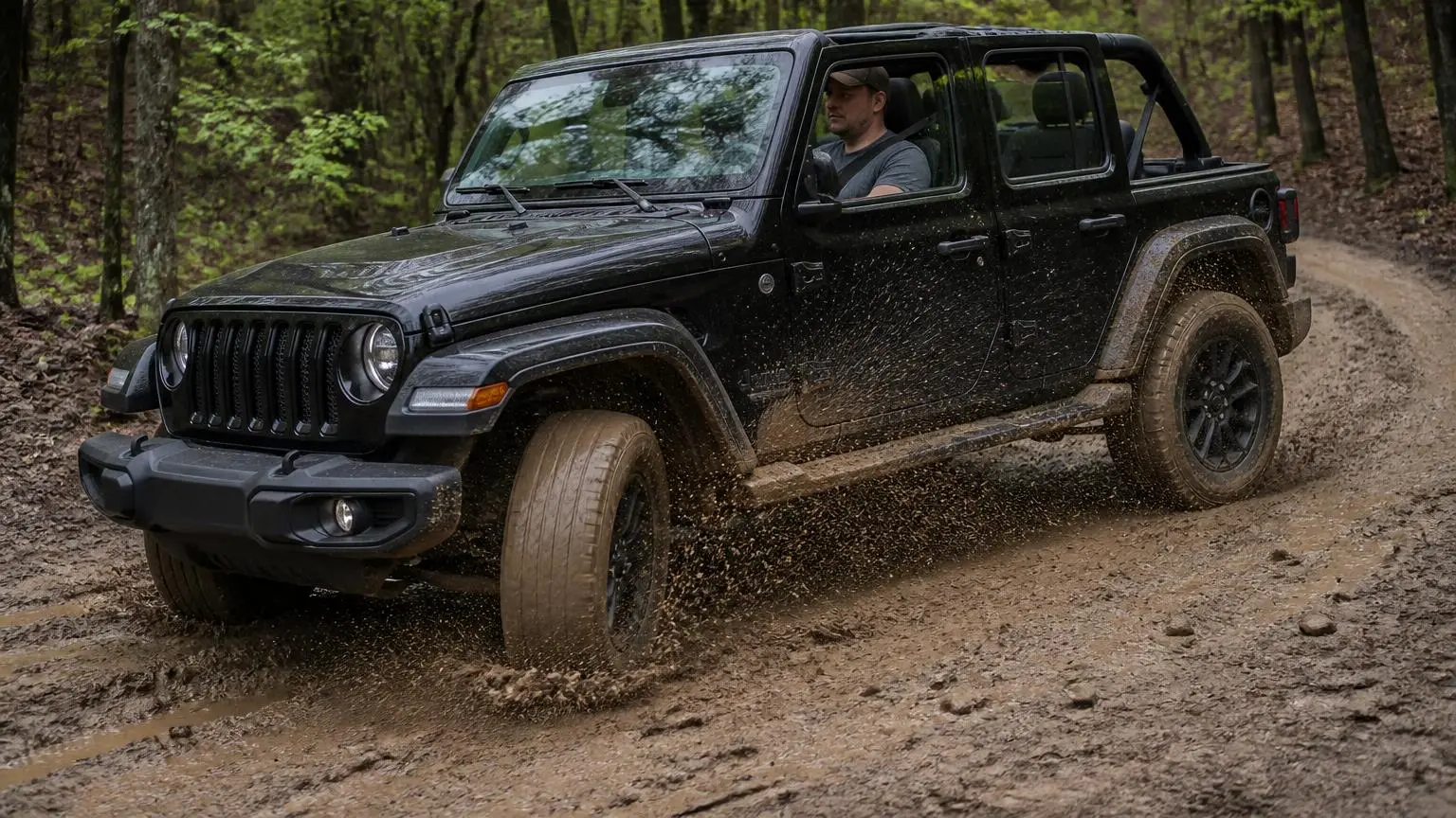 SUV turning sharply on a muddy forest track