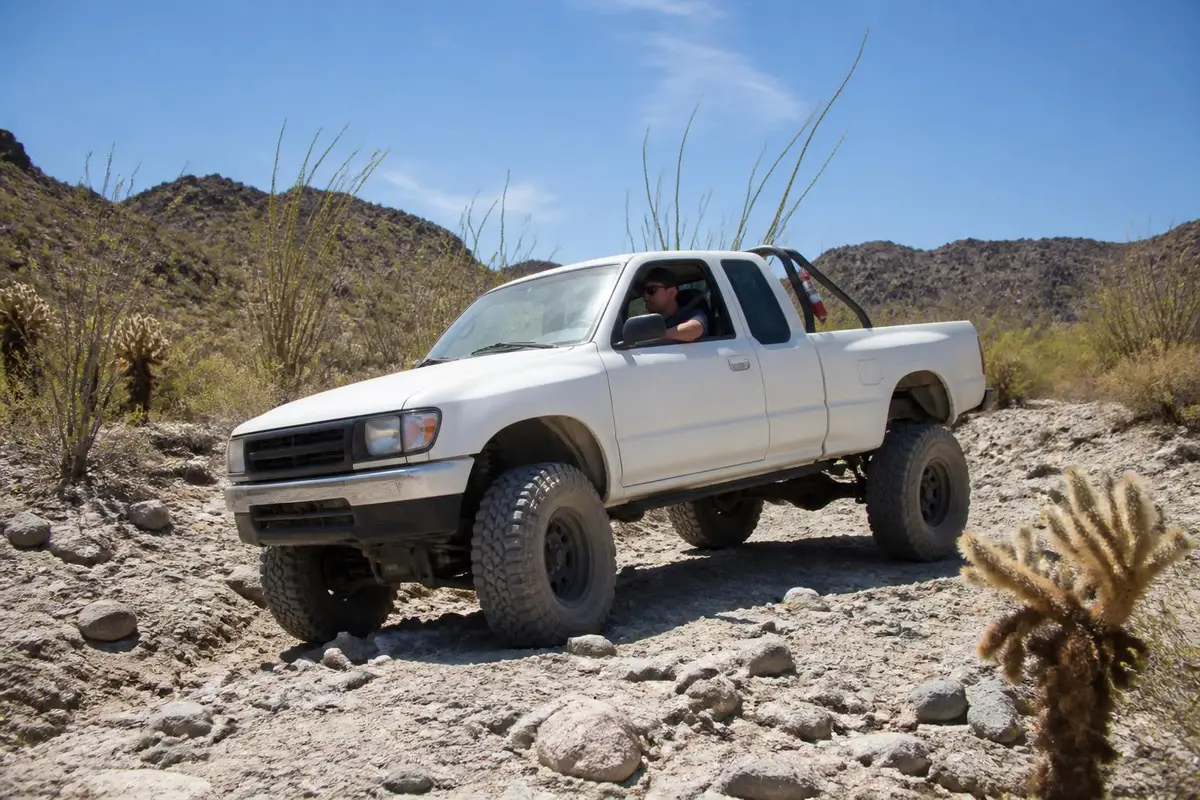 Rig on a dusty desert trail with extinguisher mounted on roll bar