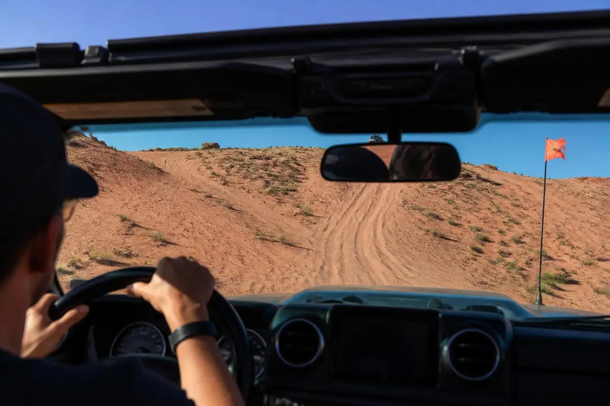 Illustrative: driver's view up a steep pink sand bowl