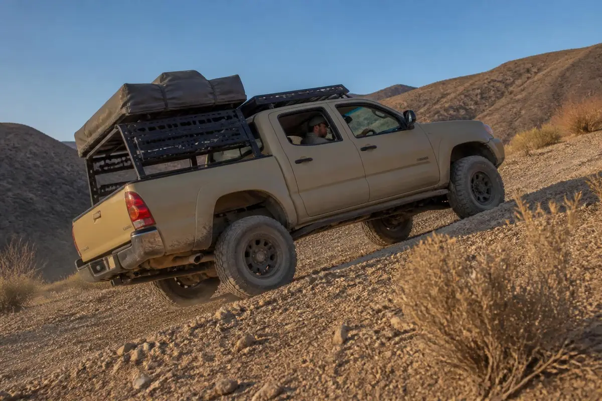 Pickup climbing a loose hill with the rear axle working