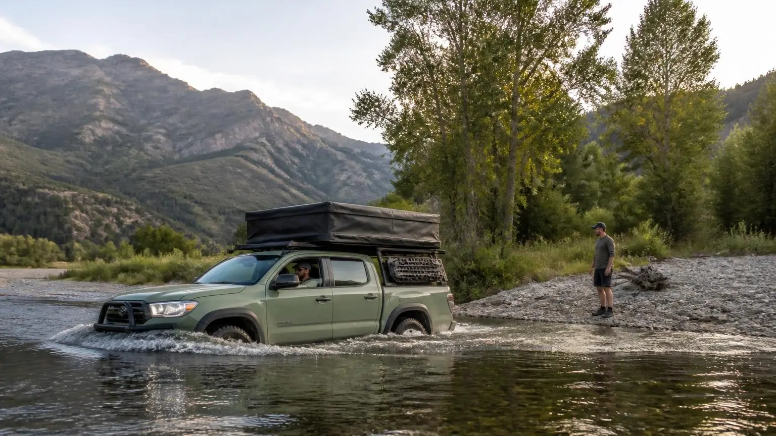 A 4WD crossing a shallow river slowly