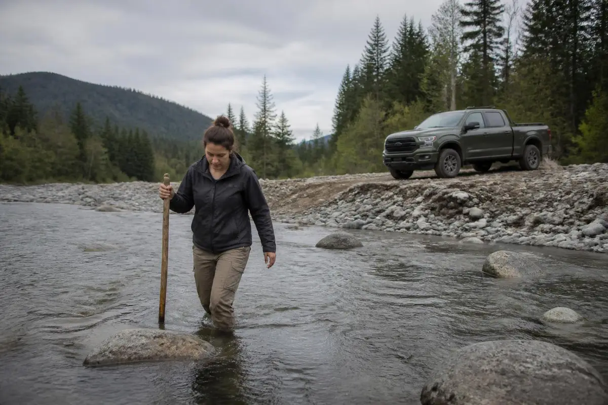 Friend walking a creek crossing to check depth