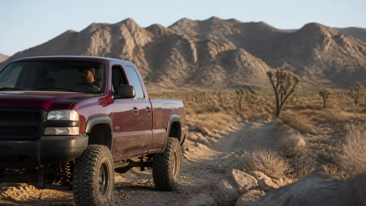 Full-size pickup on a rocky desert trail