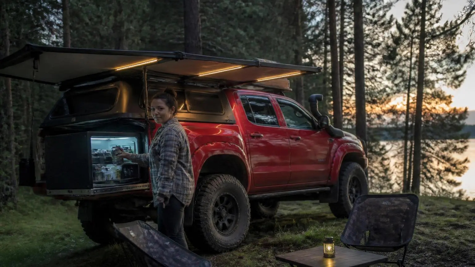 Camp fridge and lights running at a quiet forest camp