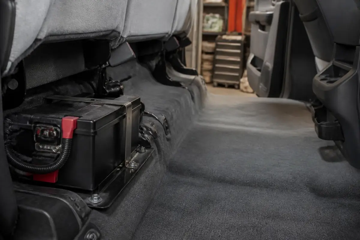 Battery mounted under a rear seat