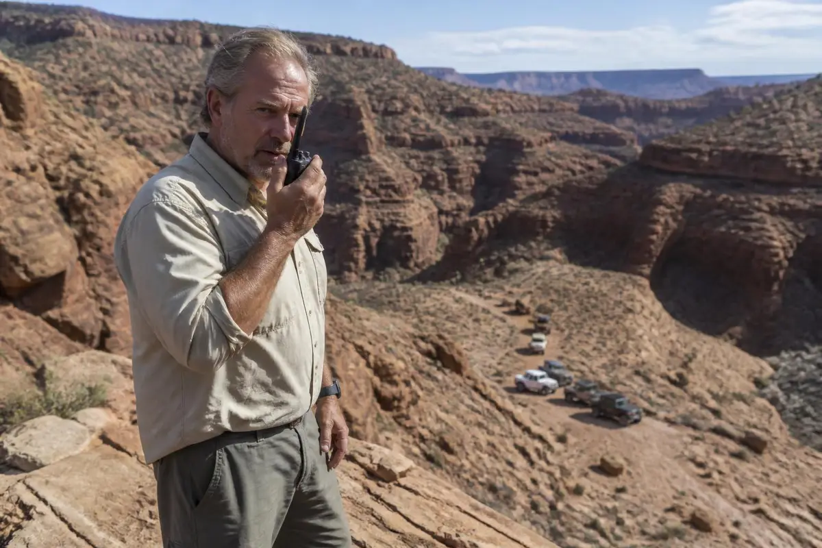 Hiker using a handheld radio on a ridge