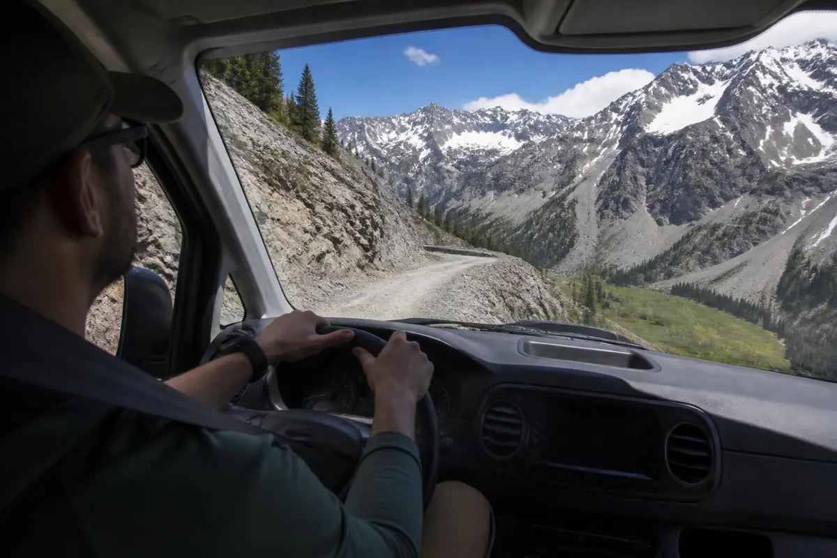 Illustrative: driver's view up a high alpine pass in the Rockies