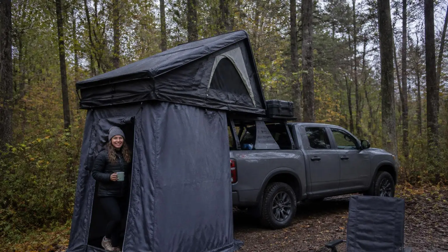 Rooftop tent with a zip-on annex room at a forest camp