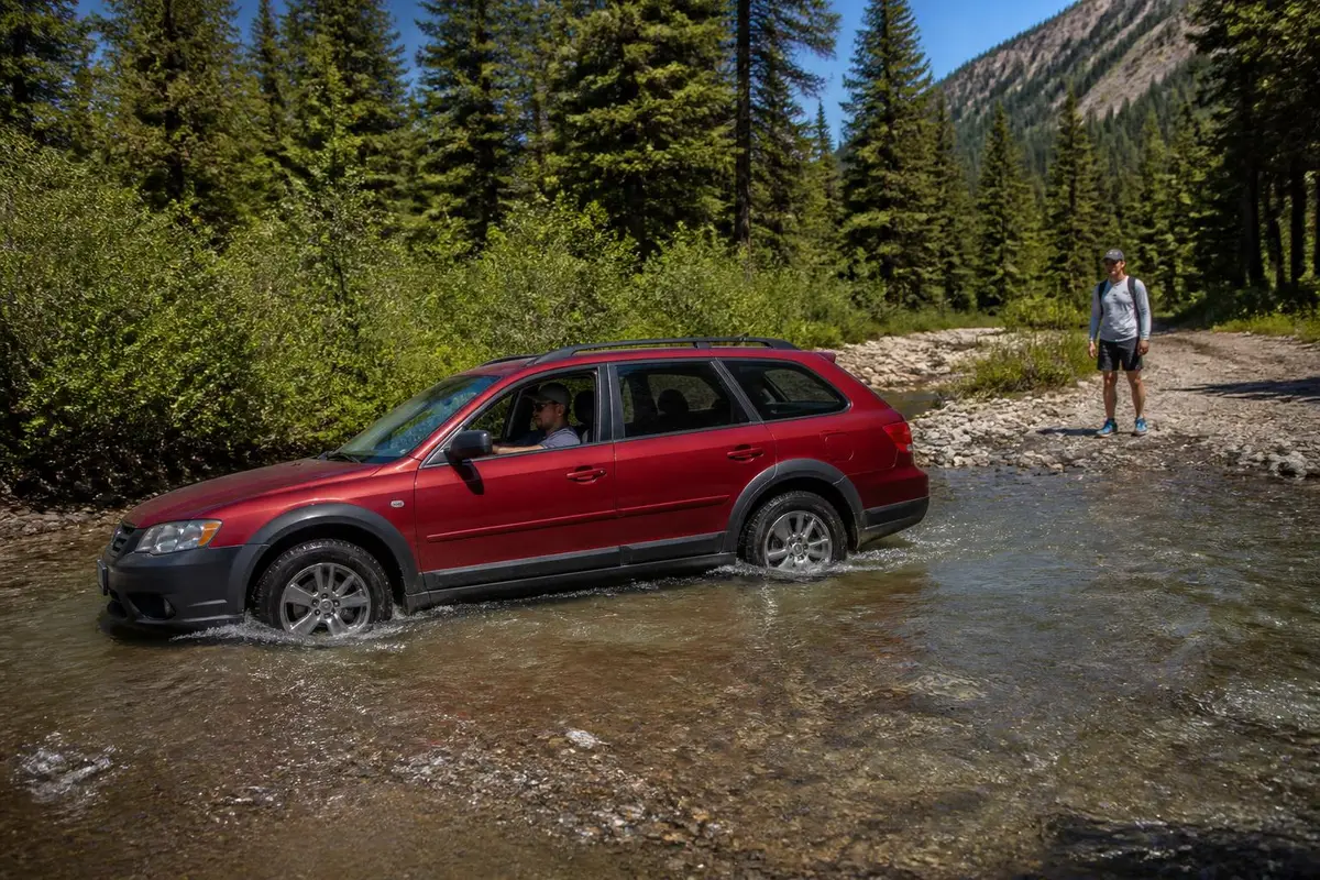Crossover wagon crossing a shallow creek slowly