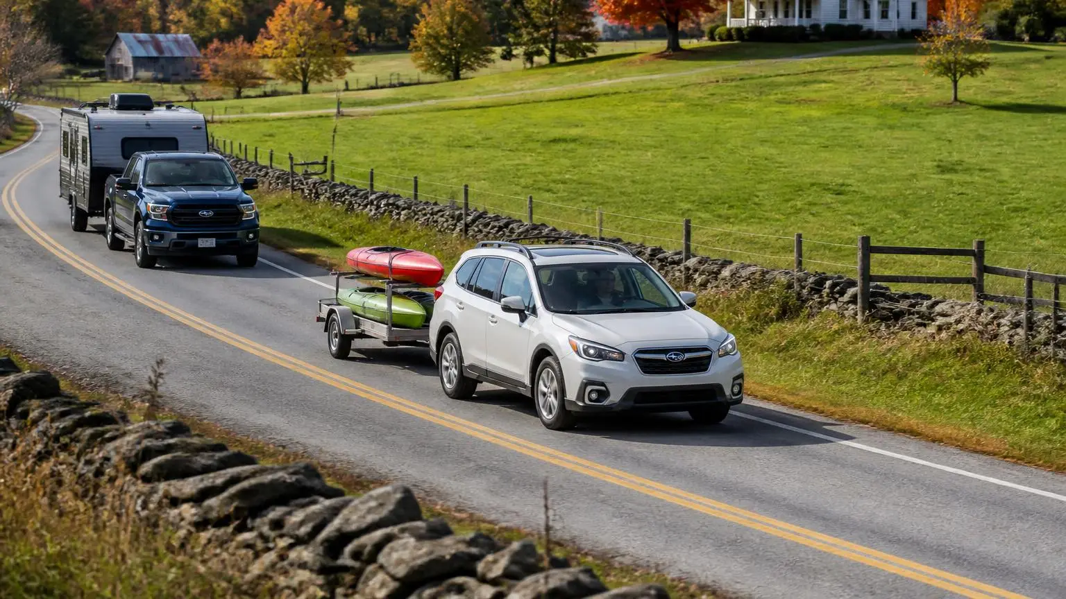 Pickup towing a small camper and an SUV towing a utility trailer on a country road