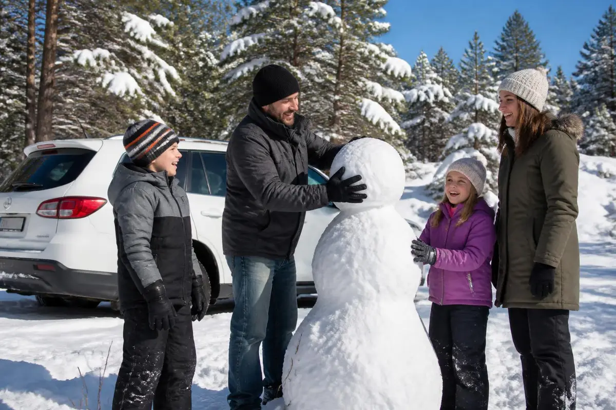 Family building a snowman beside their SUV