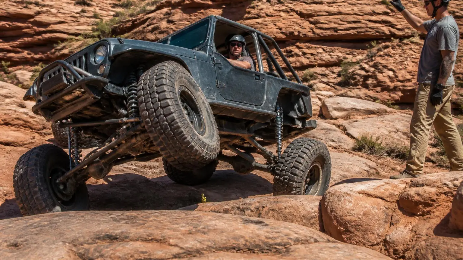 Rock-crawling rig flexing on a boulder field