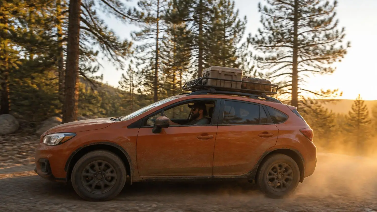 Crossover with all-terrain tires on a dusty forest road
